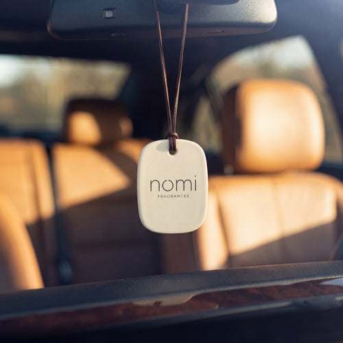 nomi car diffuser hanging from a rear-view mirror