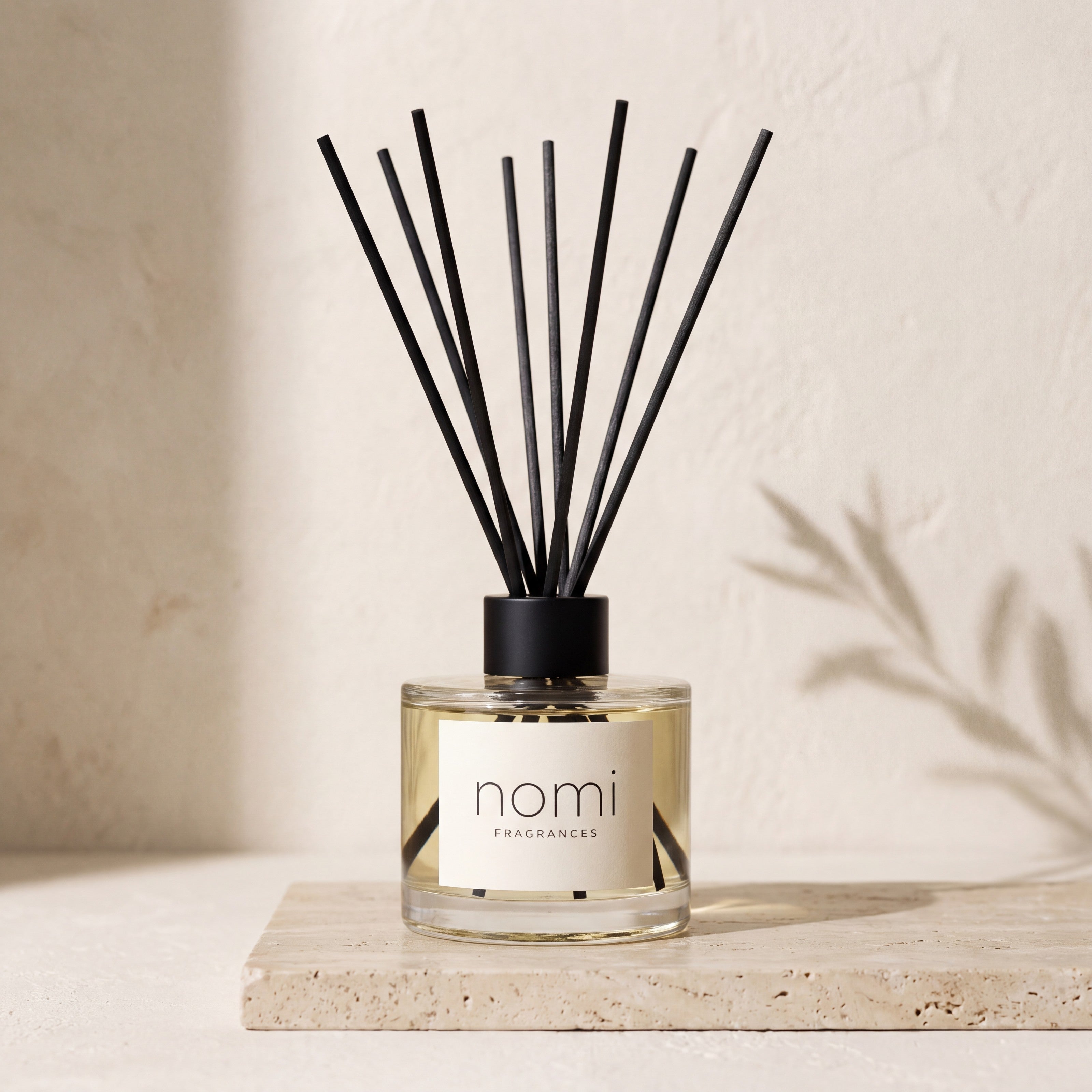 nomi reed diffuser on travertine with soft natural light