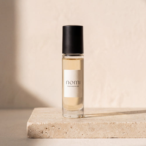 nomi roll-on perfume oil on travertine