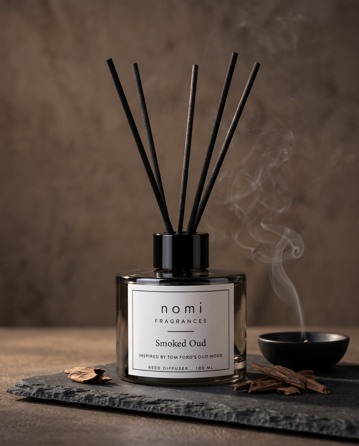 Smoked Oud reed diffuser round bottle close-up with oud wood chips